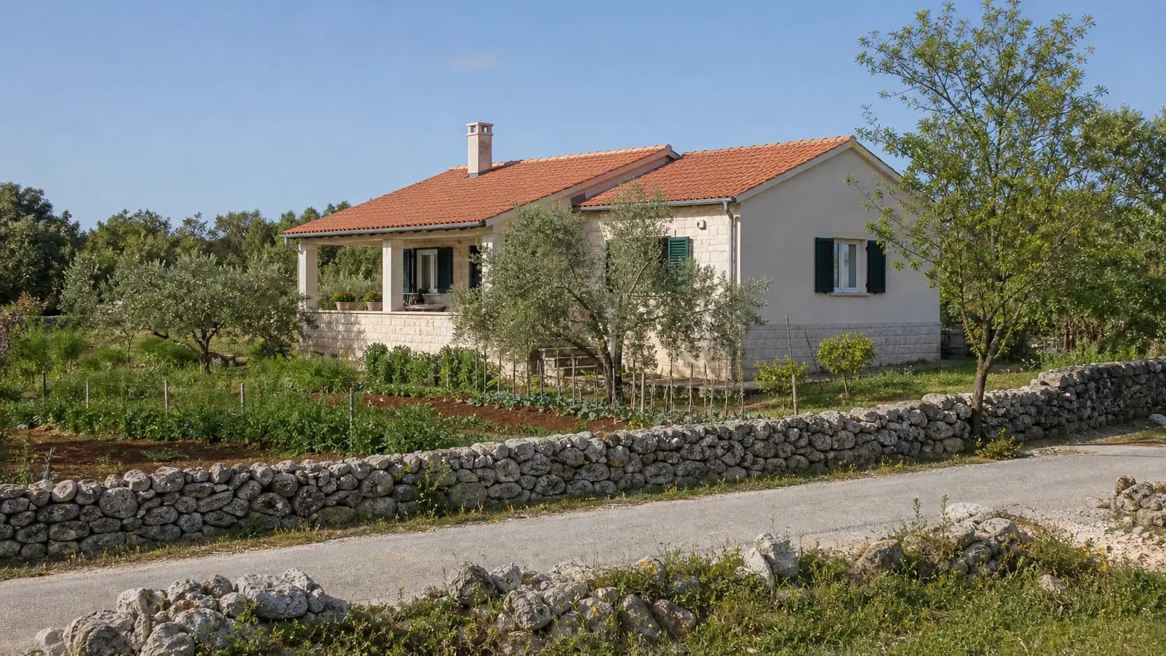 Illustrative family-home exterior with olive trees, a garden and a dry-stone wall in Donje Ceranje’s rural setting.