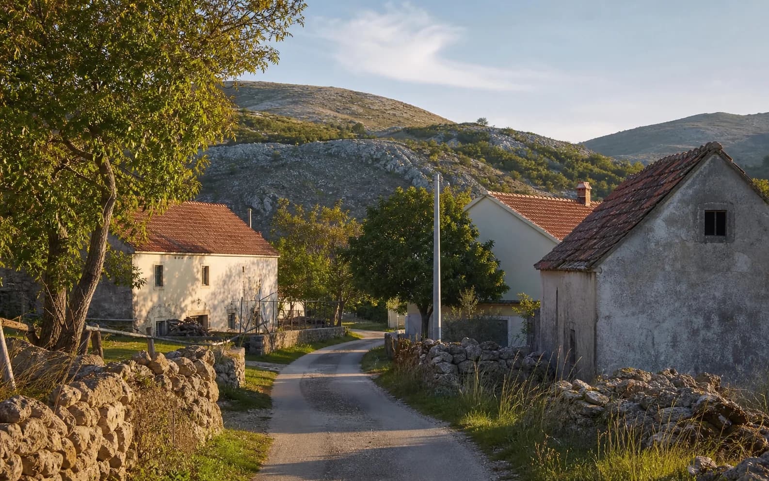 Illustrative photo for Dugopolje, Gračac: a quiet settlement street in a hilly setting.