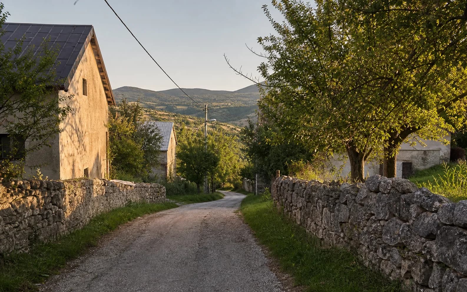 Illustrative photo for Gornja Suvaja, Gračac: a quiet settlement street in a hilly setting.