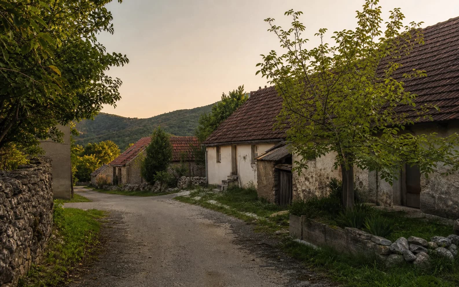 Illustrative photo for Kunovac Kupirovački, Gračac: a quiet settlement street in a hilly setting.