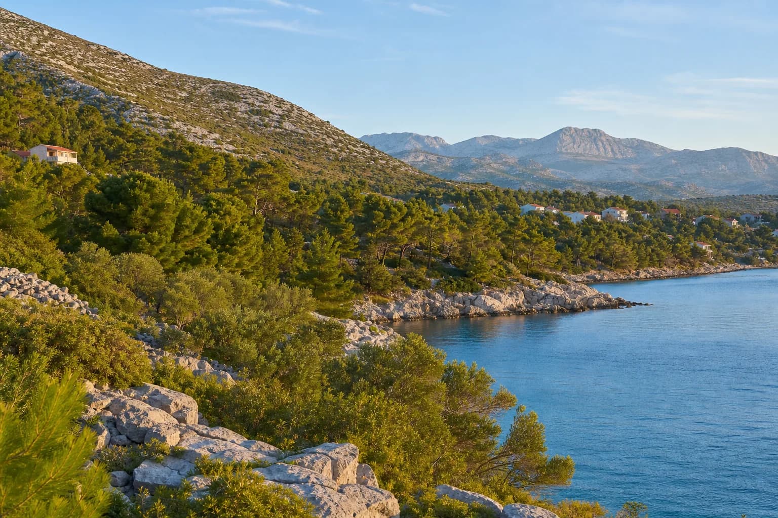 Illustrative photo for Maslenica, Jasenice: a wide view of the coast and rocky slopes.