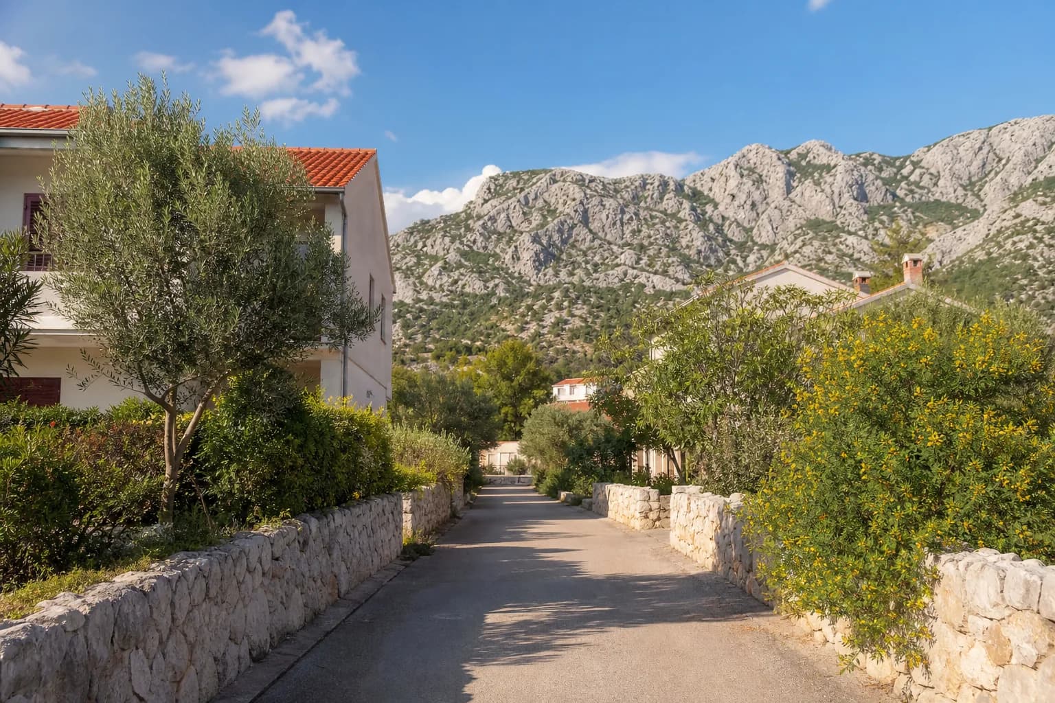 Illustrative photo for Maslenica, Jasenice: a quiet street in a rocky coastal landscape.
