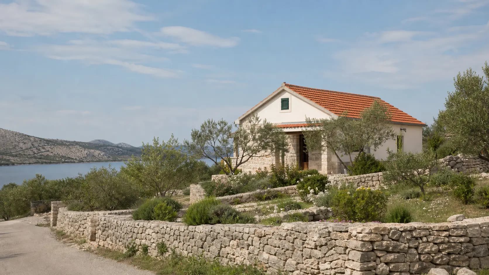 Illustrative exterior of a family home with olive trees, stone walls and a sea inlet around Kruševo.
