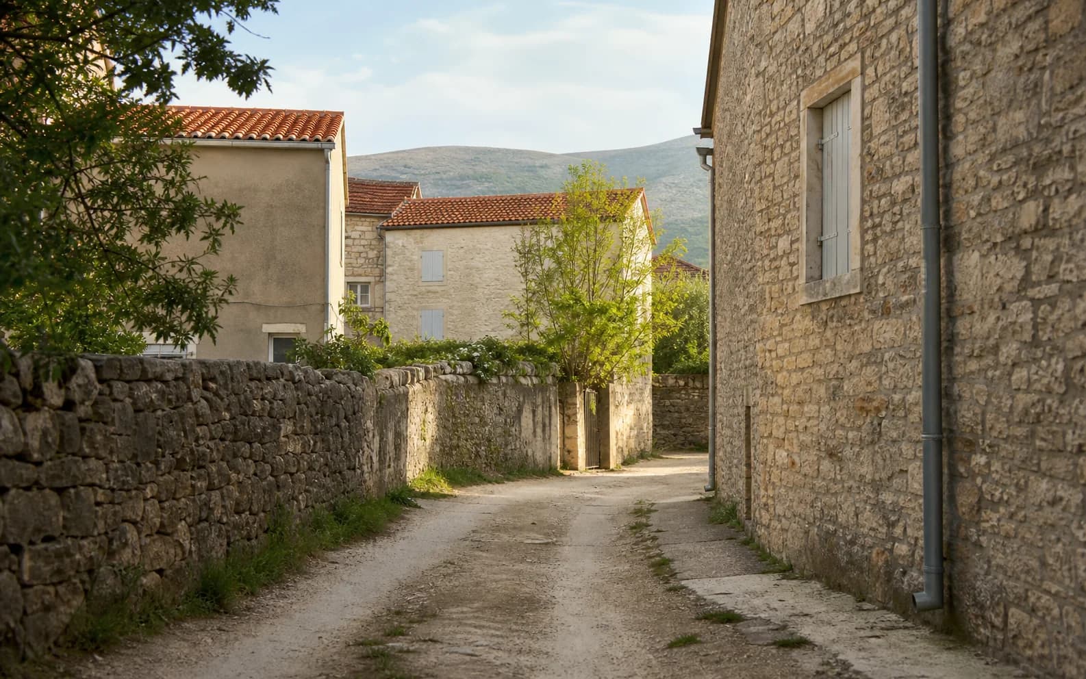 Illustrative photo for Banjevci, Stankovci: a quiet village street with natural stone details.