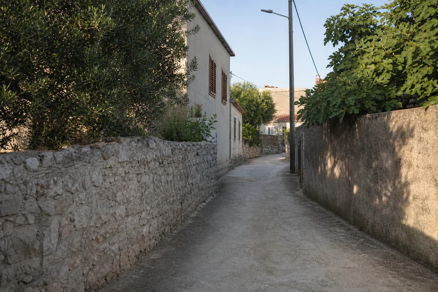 Ilustrativna fotografija za Poljica, Vrsi: mirna ulica u mediteranskom obalnom okruženju.