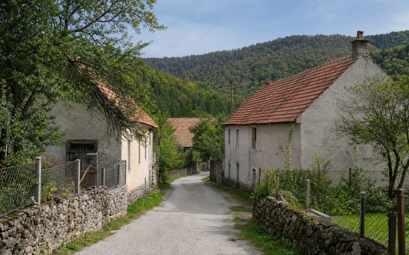 Illustrative photo for Zaklopac, Gračac: a quiet settlement street in a hilly setting.