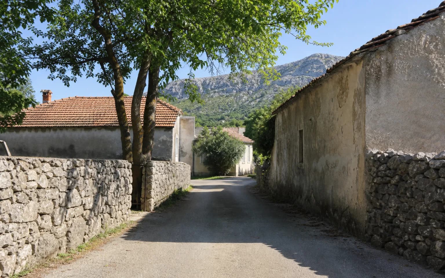 AI-generated illustrative village lane with stone walls, older homes, tree shade and a karst slope in the Krupa setting.